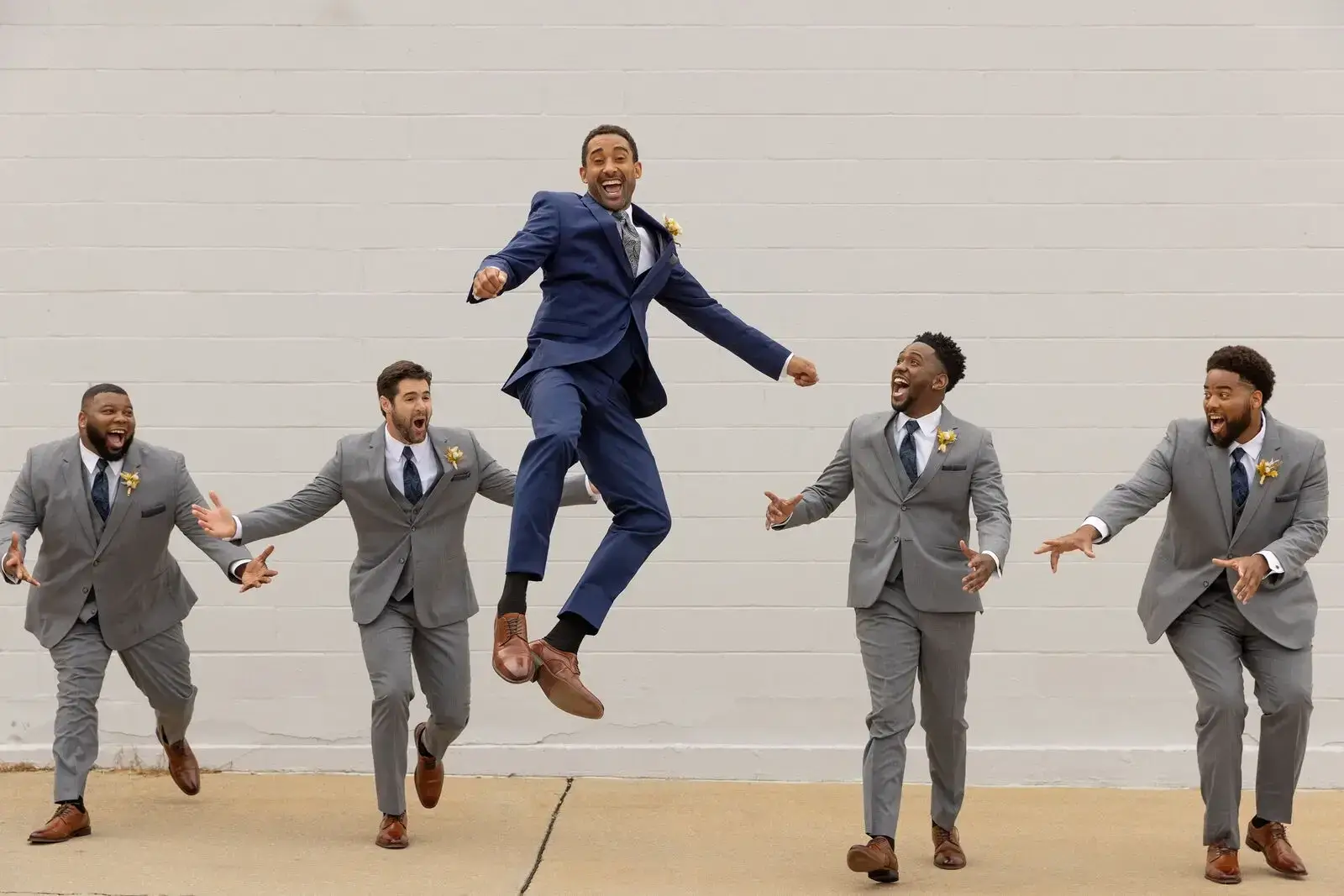 image shows models wearing suits and tuxedos in neutrals