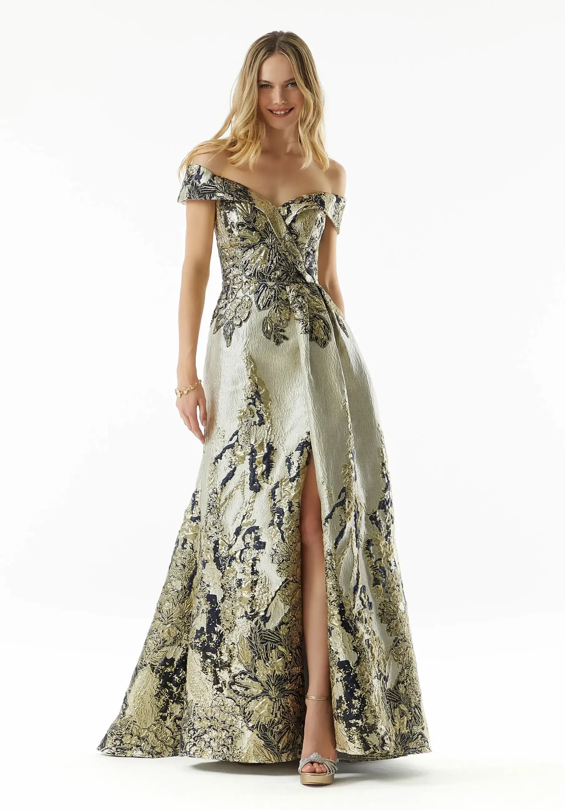 Metallic jacquard gown with surplice bodice, cuffed detail, and full skirt with front drape.