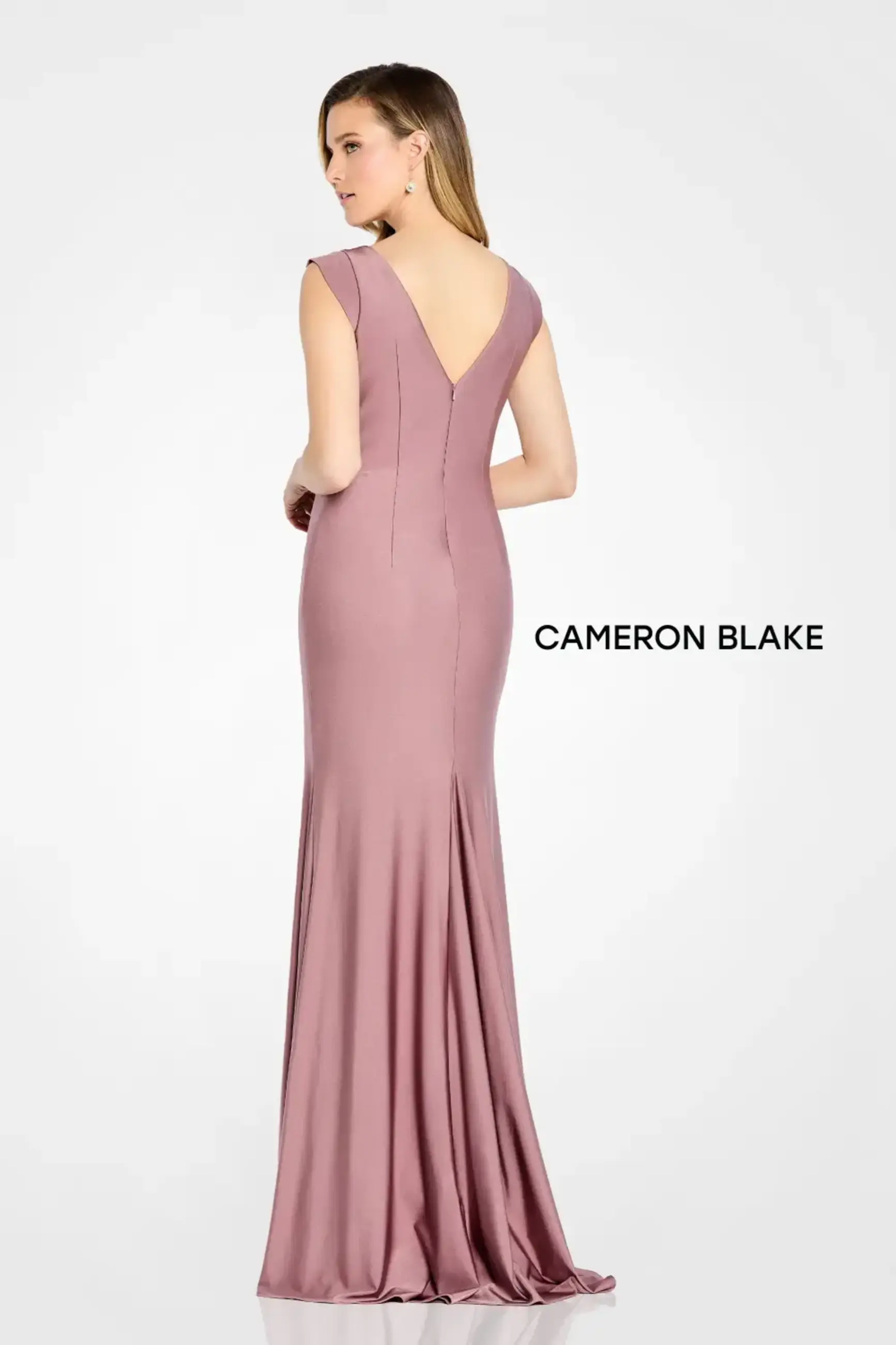 Sleeveless jersey sheath gown with ruched bodice, beaded brooch, v-neckline, v-back, and coordinating shawl.
