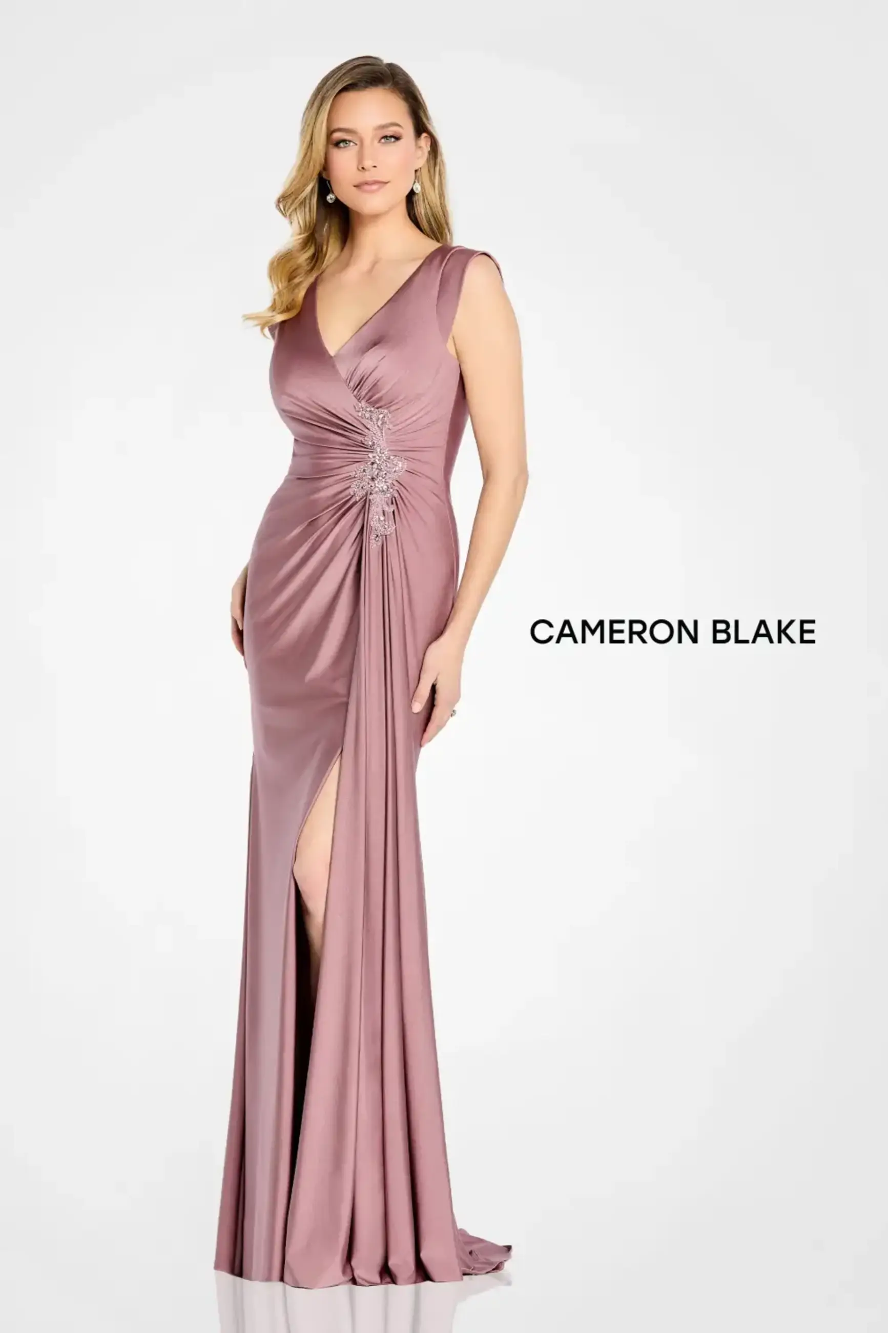 Sleeveless jersey sheath gown with ruched bodice, beaded brooch, v-neckline, v-back, and coordinating shawl.