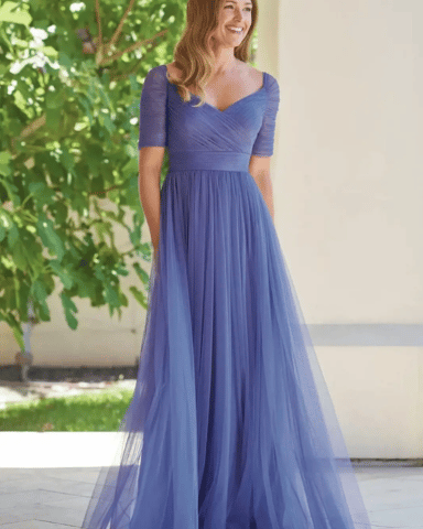 A woman wearing a light flowy fabric spring mother of the bride dress