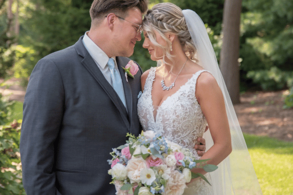 A bride and groom leaning, heads touching each other 