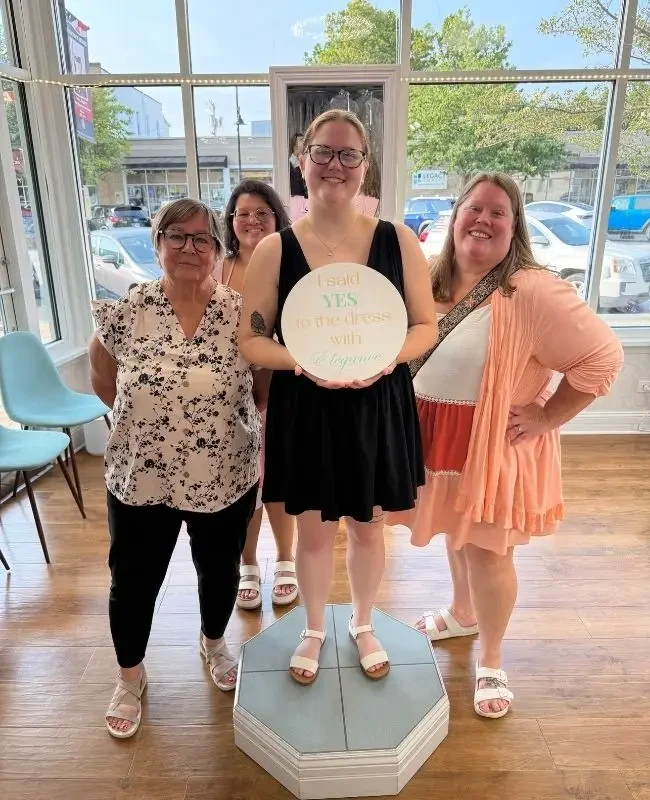 Bride celebrating her yes moment at Elegance Wedding and Evening Wear