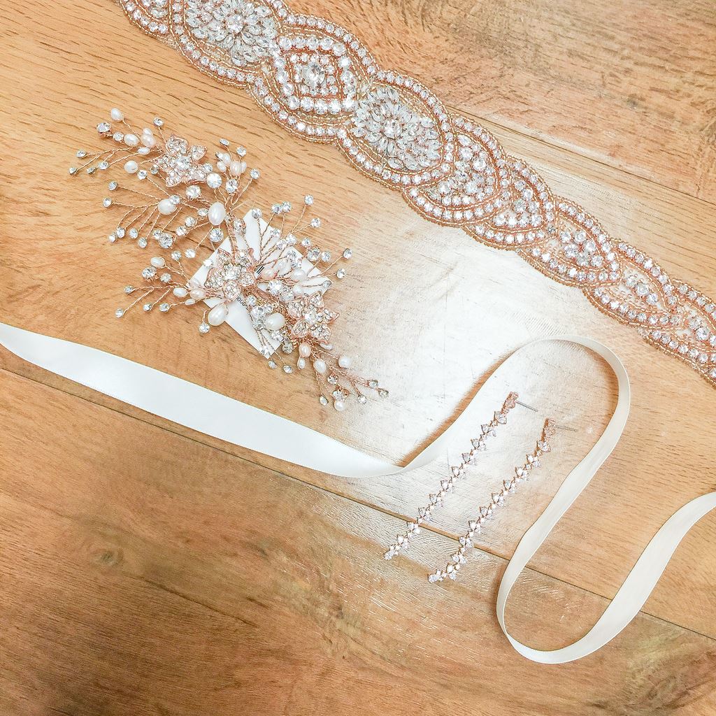 Different accessories displayed including belts and hairpieces