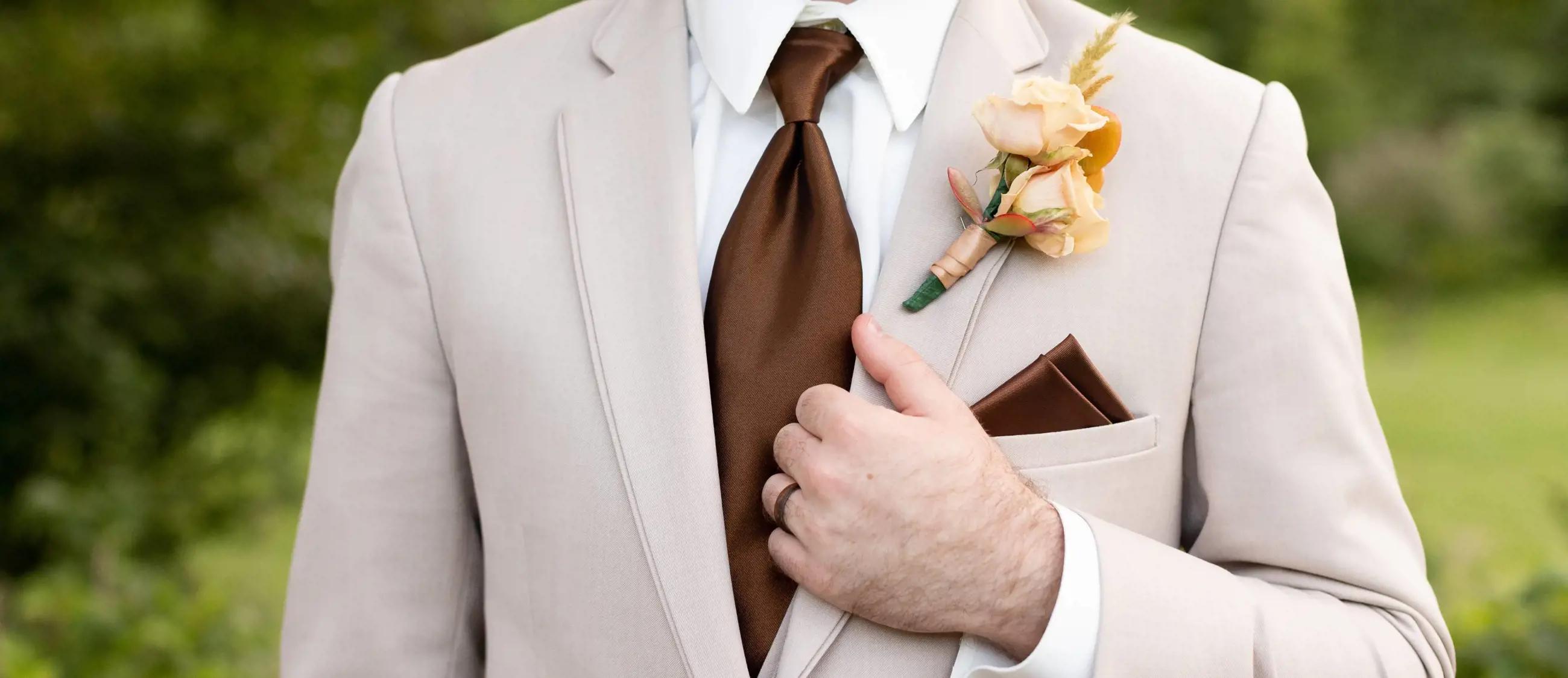 Male model wearing tuxedo and brown bow tie