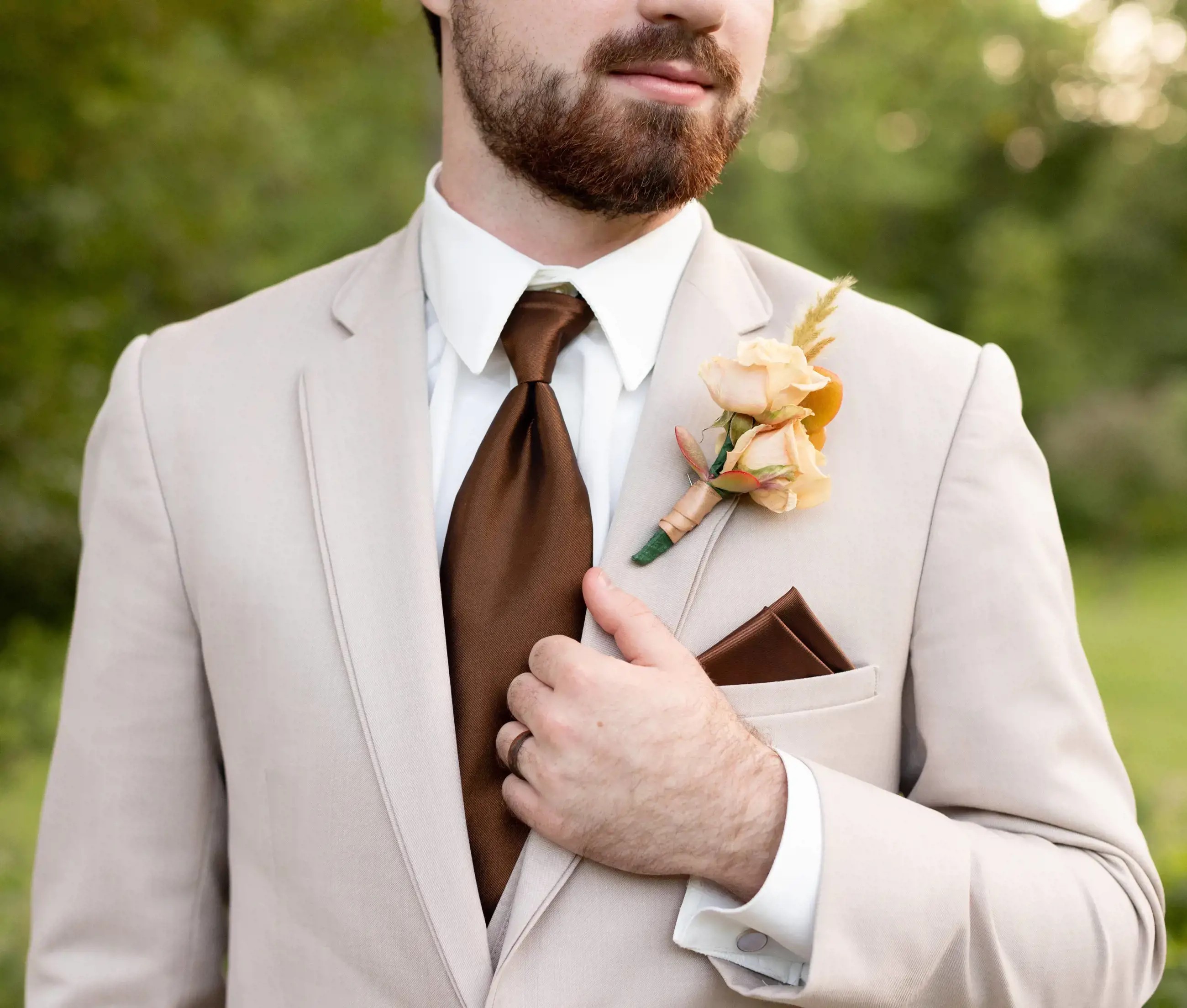 Male model wearing tuxedo and brown bow tie shown on mobile device