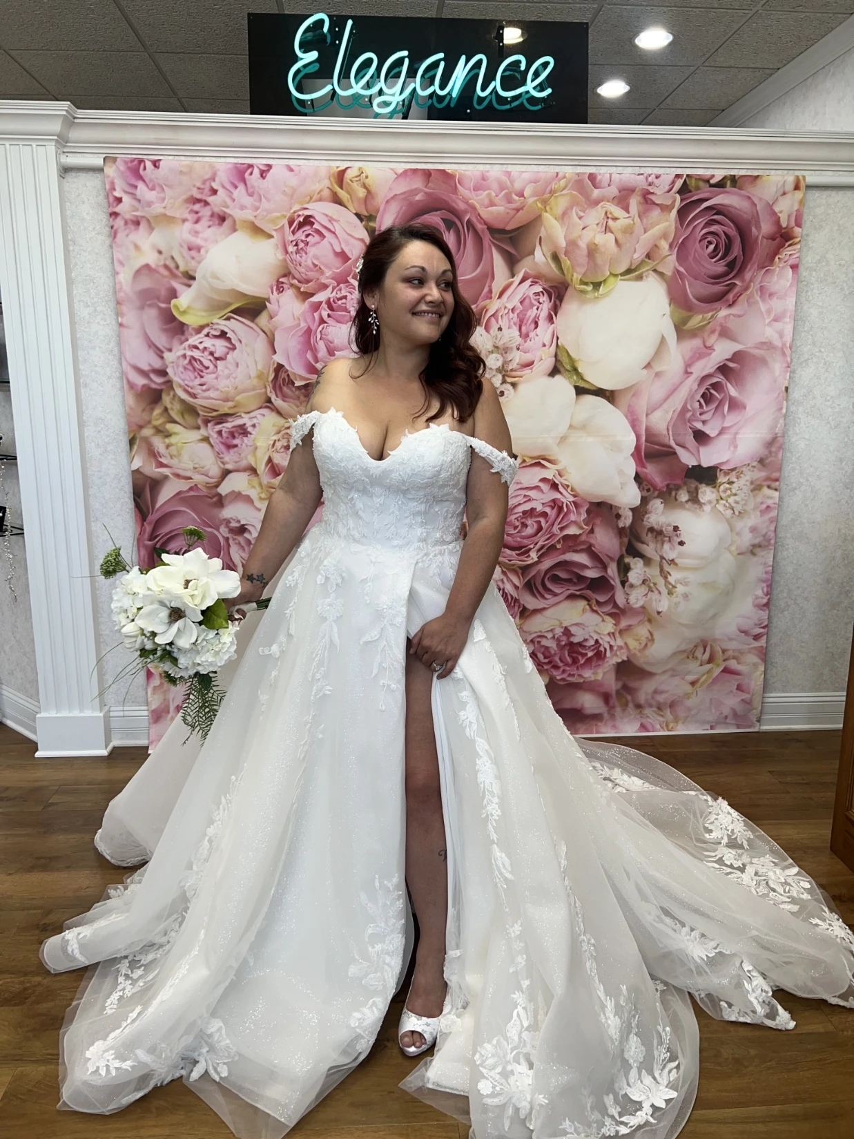 Bride in front of a sign for elegance wedding bridal shop in highland indiana